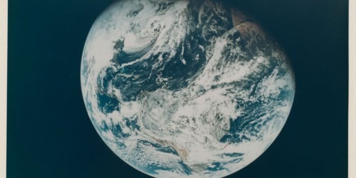 Earth from space showing Africa and the Atlantic Ocean with cloud cover across the continents.