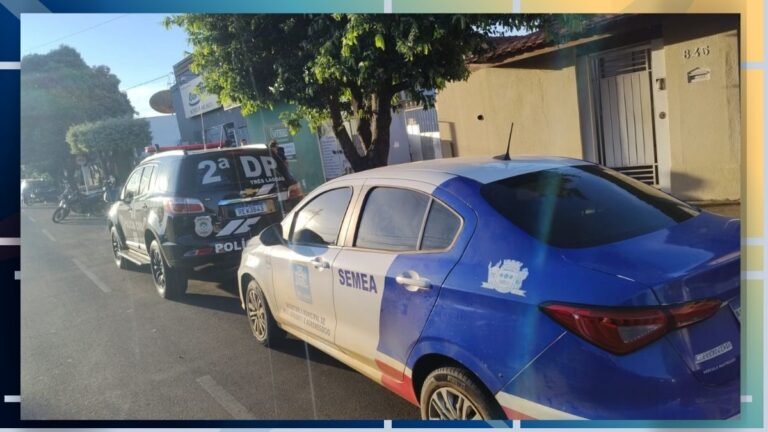 Blue and white SEMEA police sedan in the foreground on a sunlit street, with a police SUV behind and a tree in the background.