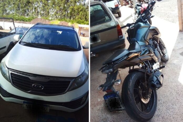 Two vehicles in a parking area: a white van on the left and a dark motorcycle on the right.