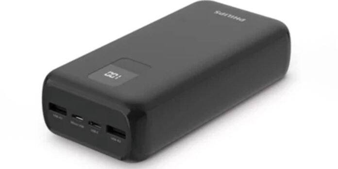 Black portable power bank with a small display on top and four USB ports on the front for charging multiple devices.