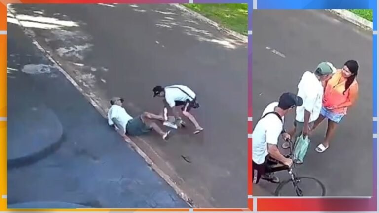 People assist a person lying on a sidewalk curb while two bystanders bend over to help