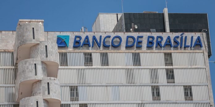 Banco de Brasília building facade with blue logo and signage against a clear blue sky