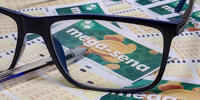 Close-up of black glasses resting on colorful Mega-Sena lottery tickets, with coins in the background and the Mega-Sena logo visible through the lenses.