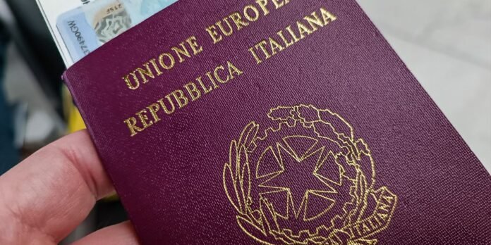 Purple Italian passport with gold emblem, held in hand, with euro banknotes visible at the top.