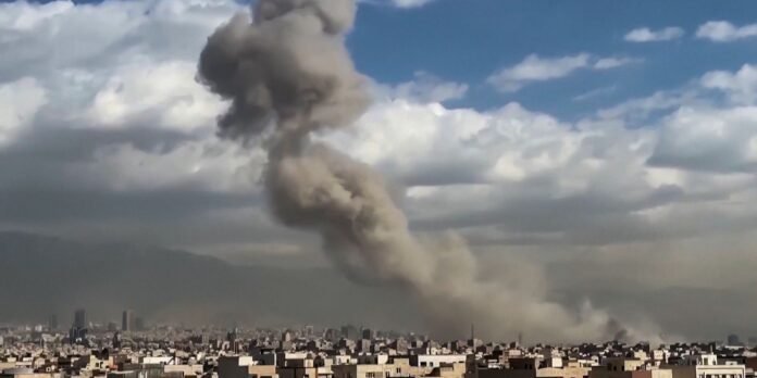 A large brown smoke plume rises above a dense city skyline, suggesting an explosion or dust cloud near the horizon.