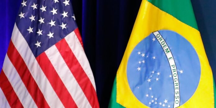 Partial view of the United States flag beside the Brazilian flag on a formal backdrop.