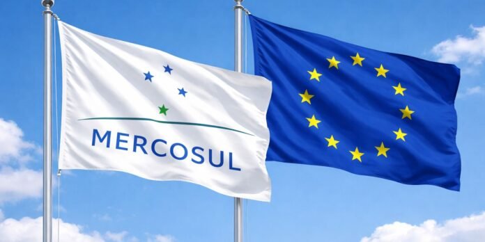 Two flags flutter side by side in a blue sky: the white MERCOSUL flag on the left and the blue EU flag with yellow stars on the right.