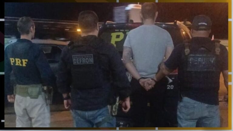 Arrest scene at night with four men standing by a police SUV; one detainee is handcuffed and escorted by officers from behind.