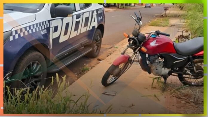Police car parked on the street beside a red motorcycle on the sidewalk, suggesting a traffic stop or incident.