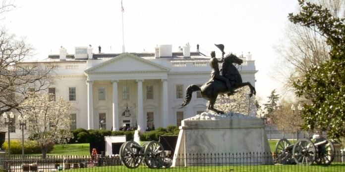 Equestrian statue of a rider on a rearing horse in front of the White House, with cannons surrounding the pedestal