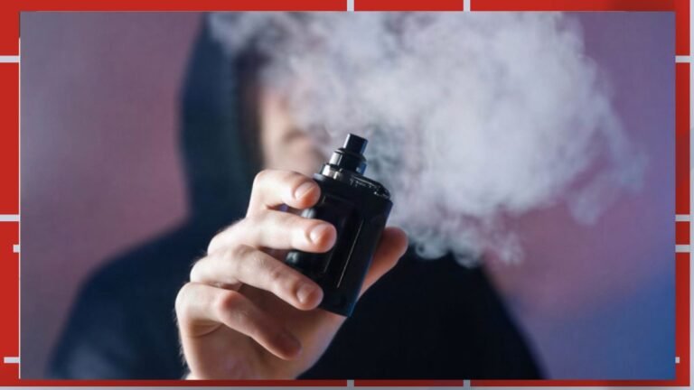 Person holding a vape mod and exhaling a cloud of vapor toward the camera