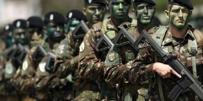 Line of soldiers in camouflage uniforms with face paint, marching in formation and carrying rifles in a drill.