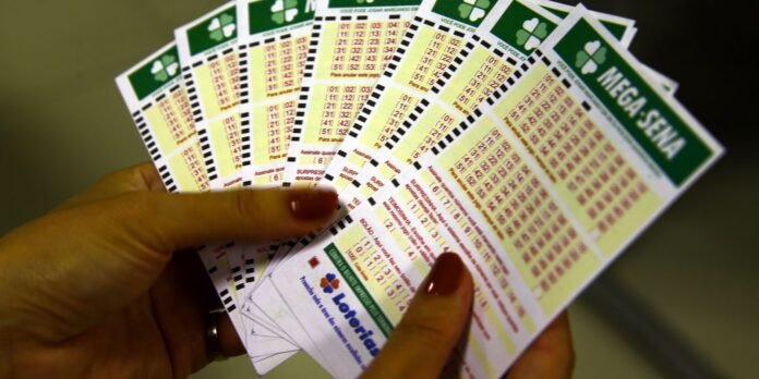 Person holding multiple lottery tickets fanned out, showing bright green tops and numeric grids