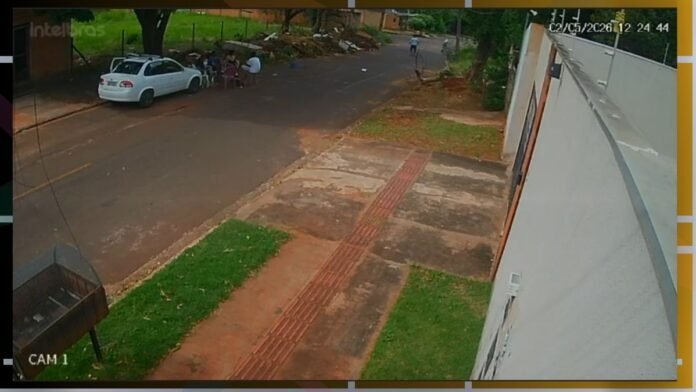 CCTV image from CAM 1: a white car parked on a residential street with a small group of people nearby and a sidewalk with red tactile paving along a wall on the right.