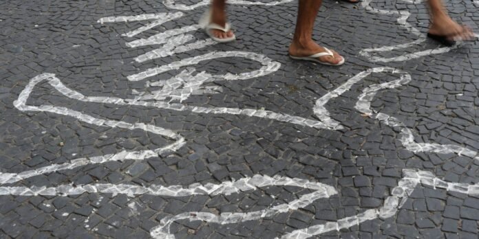 Cobblestone pavement with white chalk maze lines; two people in flip-flops step across.