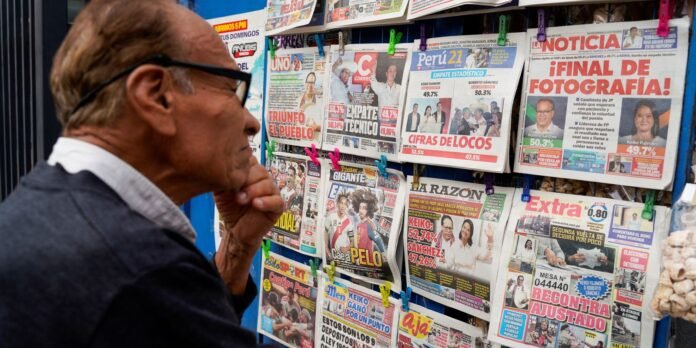 Older man with glasses reads a colorful newspapers stand on a street, examining headlines