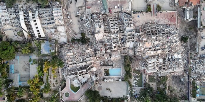 Aerial view of extensive building rubble and collapsed structures in a neighborhood.