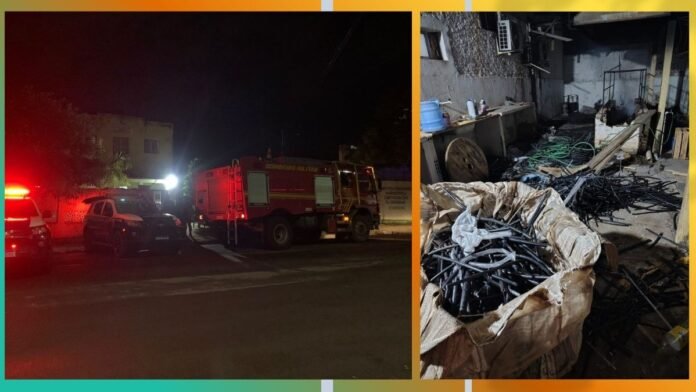 Two-panel scene: left shows a red fire truck and responders at night; right shows a cluttered workshop with piles of black metal rods, cables, and debris.