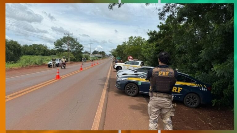 PRF officer in tactical vest overlooking a rural highway blocked by orange traffic cones and parked patrol cars.