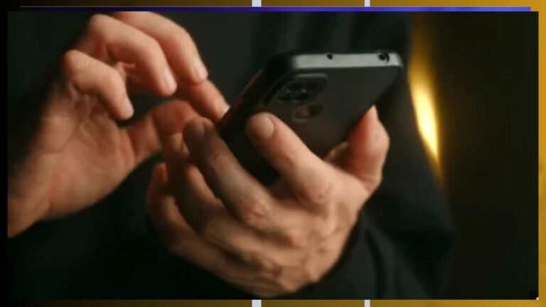 Close-up of hands holding a smartphone, fingers poised to tap the screen in a dim, warm-lit setting.