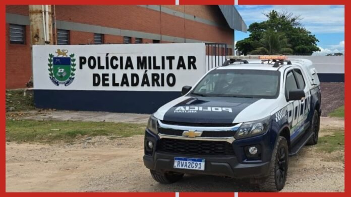 Police pickup truck in front of a sign that reads 'Polícia Militar de Ladário' with a crest on the left side (Brazil).