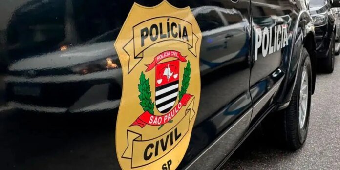 Dark police car with a large yellow São Paulo Civil Police badge on the door.