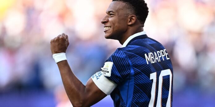 Soccer player in a blue jersey with the number 10 celebrating, fist raised in victory