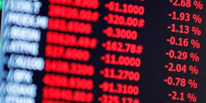 Stock market board showing red downward price numbers, indicating market declines.