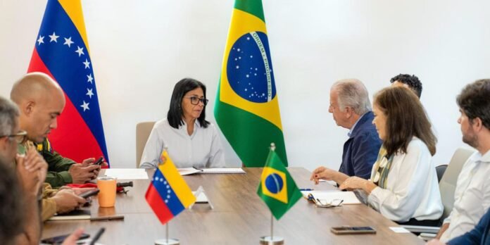 Diplomatic meeting around a conference table with Venezuela and Brazil flags visible in the background.