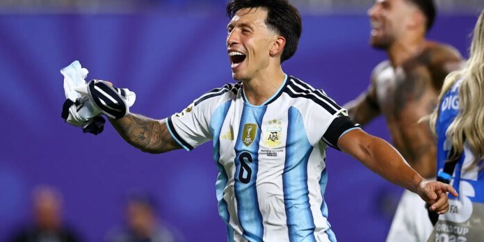 Argentine soccer player celebrating with arms outstretched, wearing a blue-and-white striped jersey after a win.
