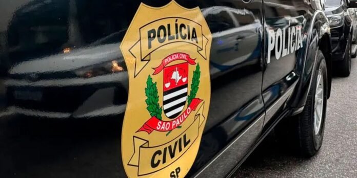 Close-up of a black police car door displaying the yellow São Paulo Civil Police emblem.