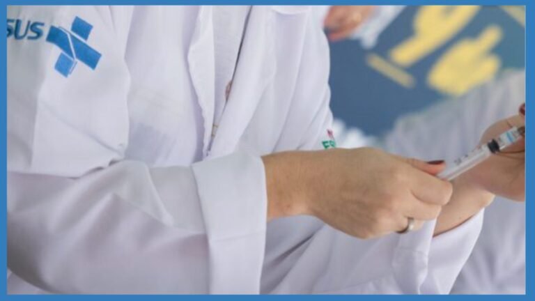 Medical professional in a white coat drawing a syringe for vaccination.