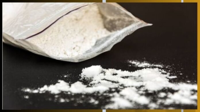 Open bag of white powder spilling onto a dark surface.