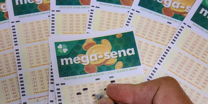 Close-up of Brazilian Mega-Sena lottery tickets with a hand selecting numbers on one slip