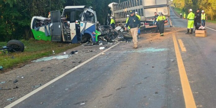 Emergency responders at a multi-vehicle crash scene with a damaged bus off the road and a truck nearby; debris and broken glass scattered across the roadway.