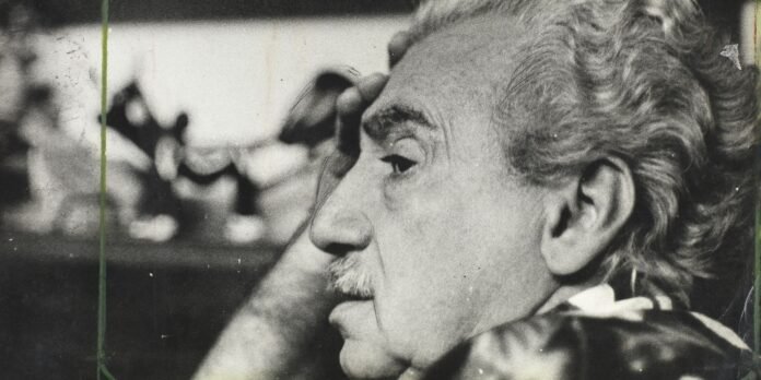 Close-up black-and-white profile of an elderly man with a mustache, looking thoughtful.