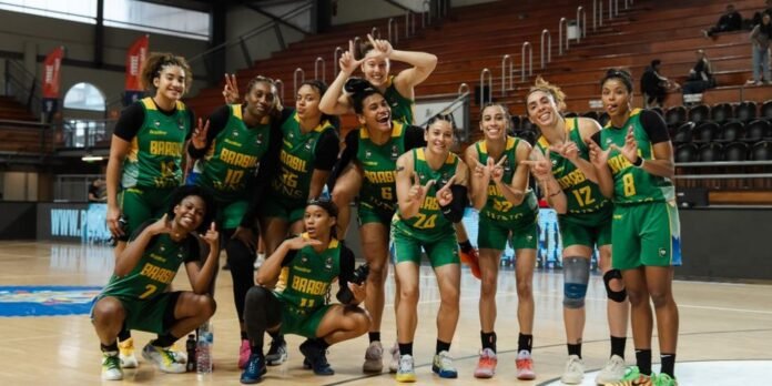 Brazilian women's basketball team posing together on the court, making peace signs and smiles after a game win.