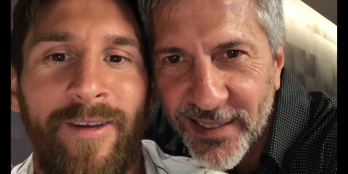 Two men taking a close-up selfie, both smiling at the camera.