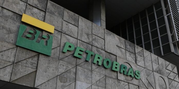 Concrete building facade featuring a green Petrobras sign with a yellow bar logo above it.