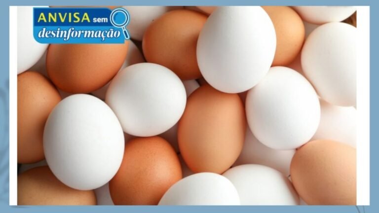 Close-up of brown and white eggs piled together with a blue ANVISA sem desinformação badge in the top-left.